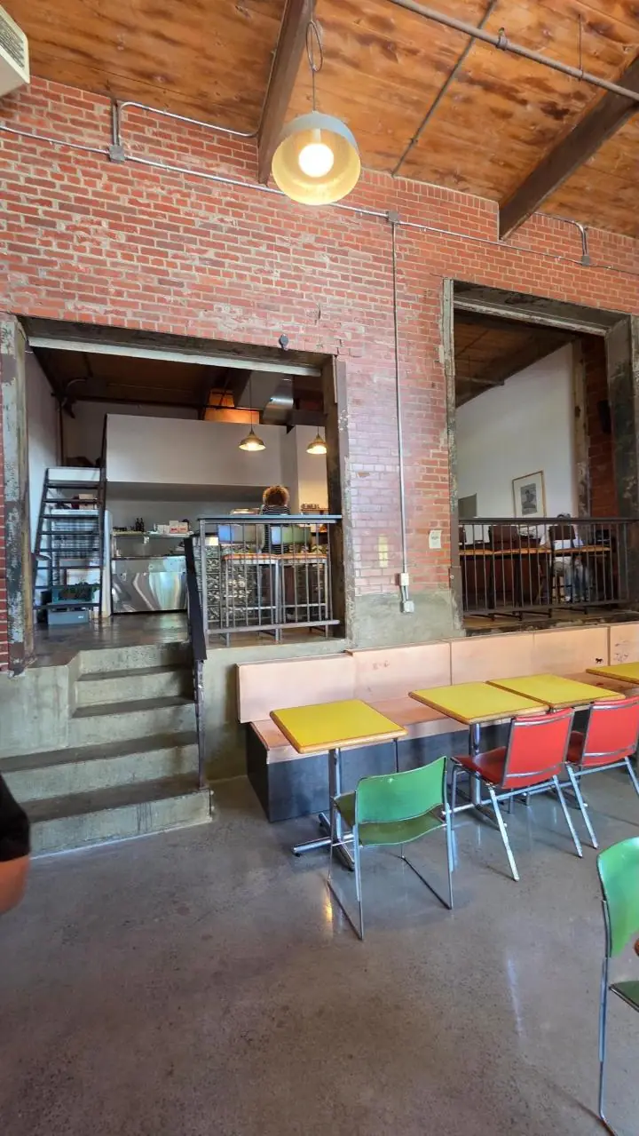 Concrete steps up to the mezzanine beside the banquettes