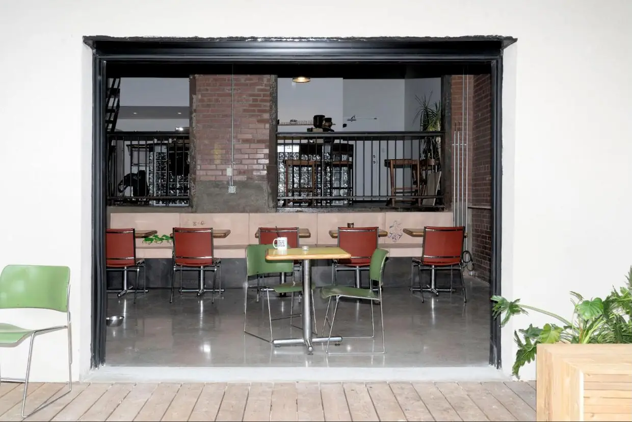 The room seen through the open garage door from the patio