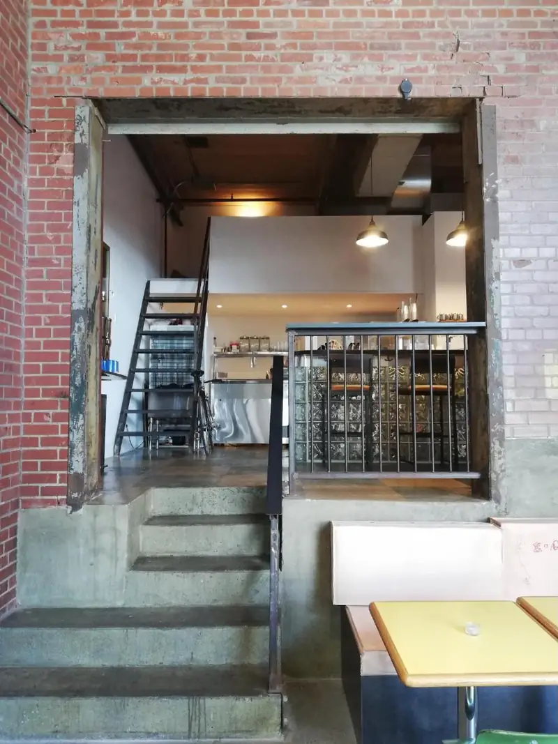 The mezzanine kitchen window framed in old brick