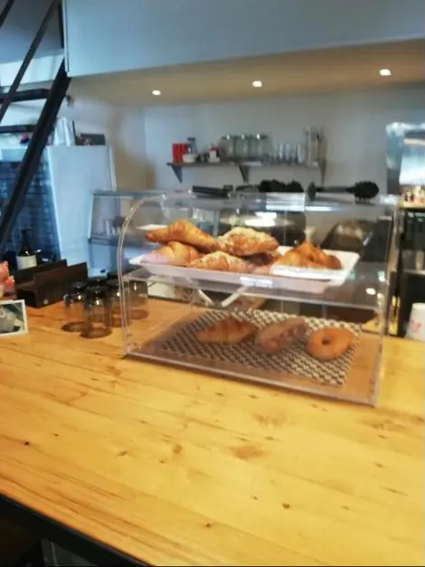 Croissants and pastries in the case on the pine counter