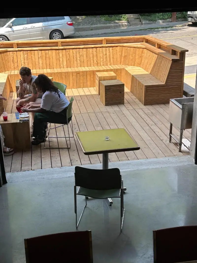 Looking out the open garage door at people on the patio